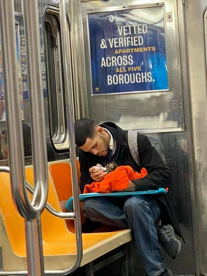 "Facet karmiący kociaka w metrze"
